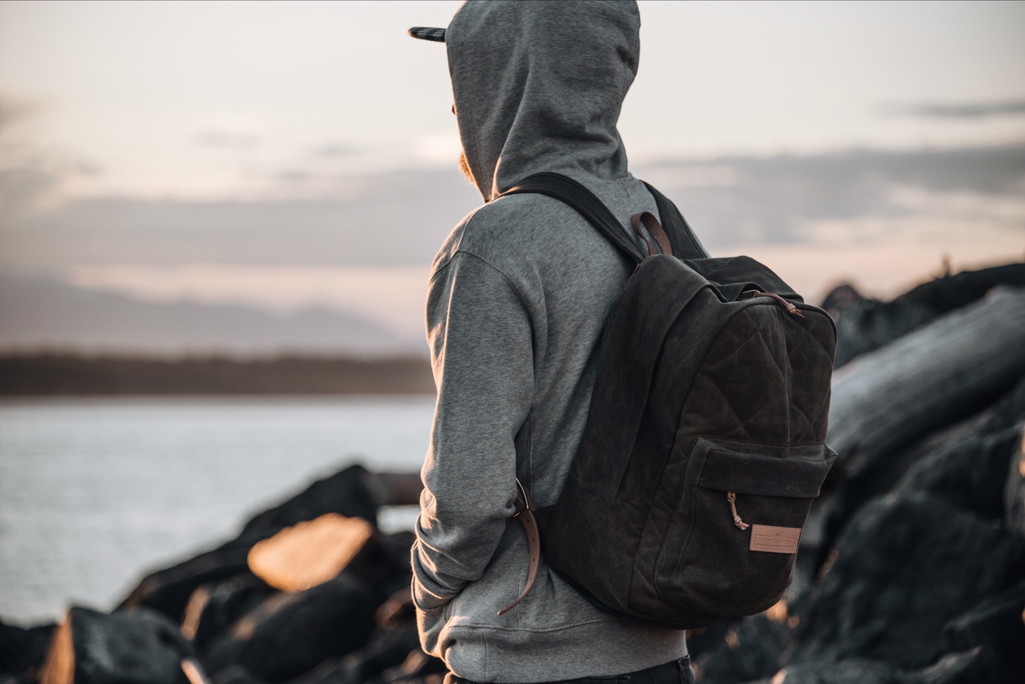 Man wearing a tan Junction Backpack